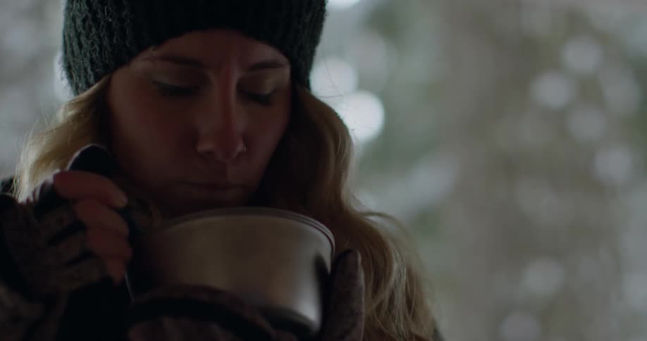 Woman takes a sip out of a large container