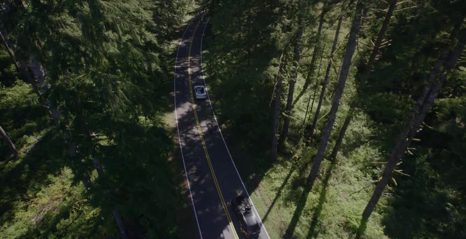 A white car driving down the road