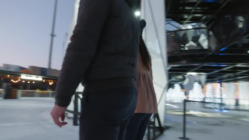 Couple play ice skating at the park