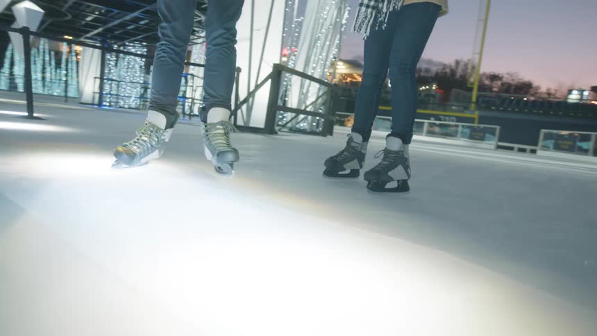 A shot of couple play ice skating at the park