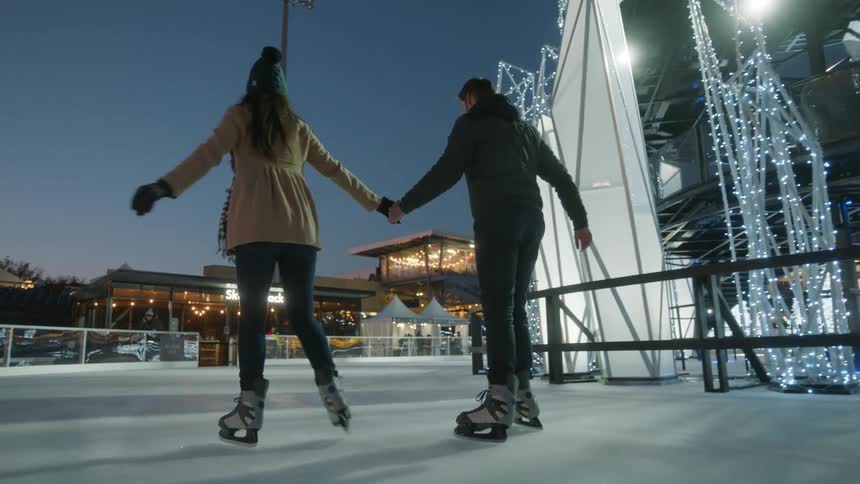 Couple play in the ice skating at winter