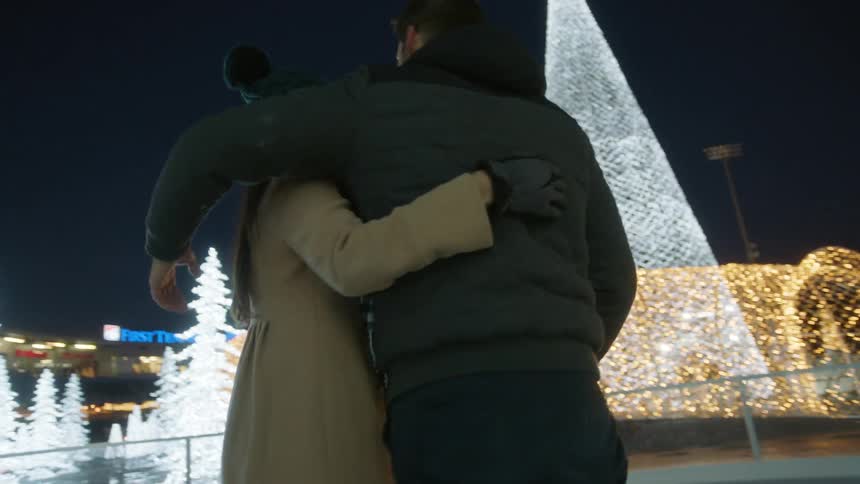 A couple watches the tree lighting