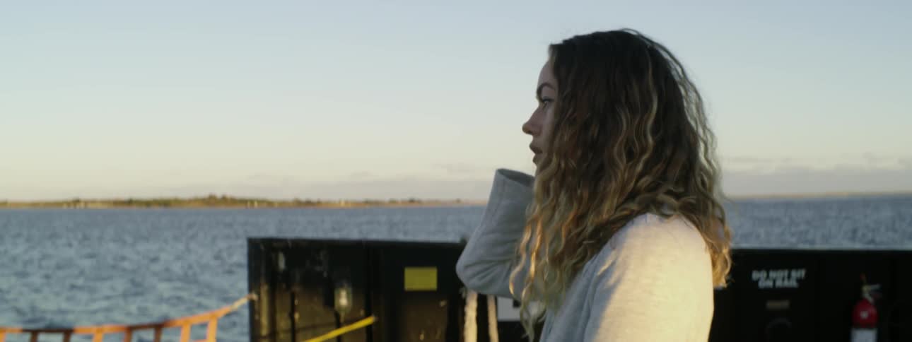 A woman looks out at the water