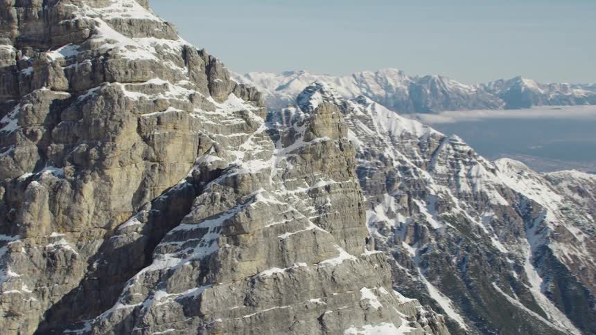 An aerial view of a snow capped mountain range