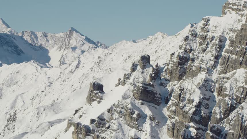 A mountain peak peeks out under a blanket of snow