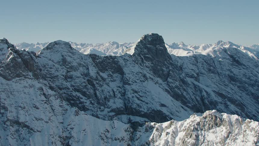 Aerial view of the snow covered summit of a mountain range