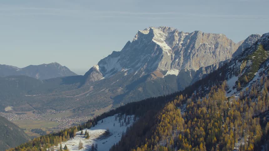 An aerial view of mountains with snow on them