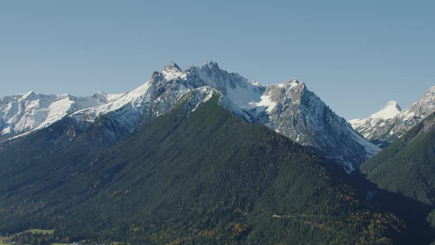 The vast mountain range is under a clear sky