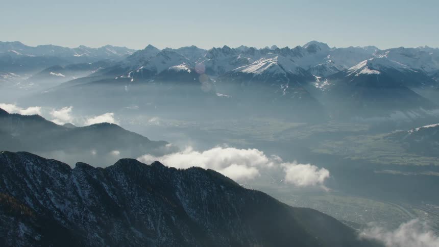 An aerial view of a mountain range with snow