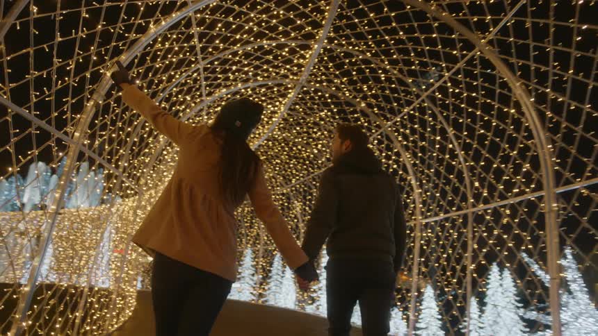 Couple walk trough the light tunnel