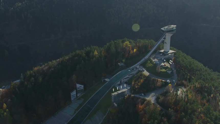 An observation tower sits on the top of a tall hill