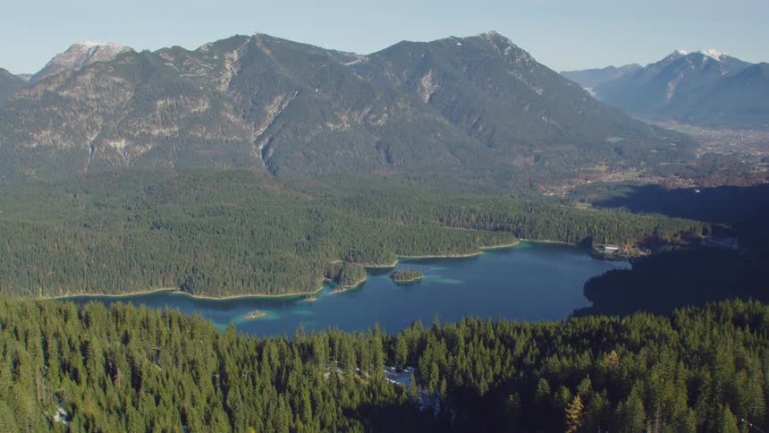A lake in a verdant mountain valley during the day
