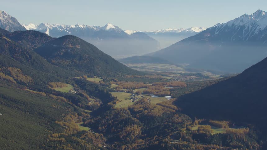 A verdant mountain valley under a clear blue valley