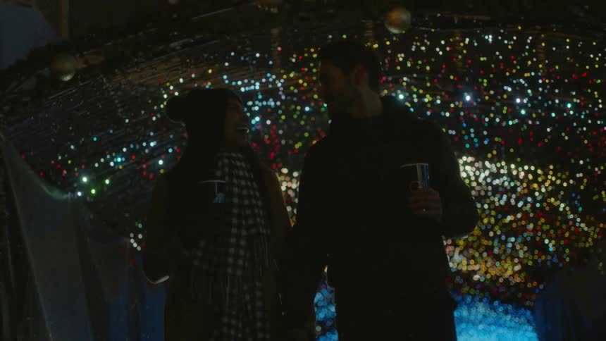 Male and female are holding hands outdoors