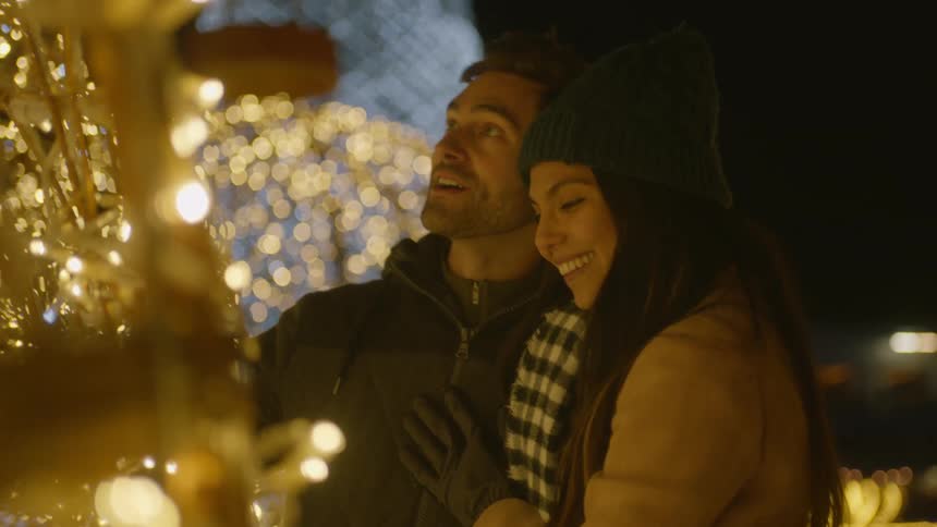 Couple take a closer look at the christmas light decoration
