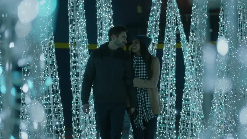 Couple walking on the christmas light decoration at the park