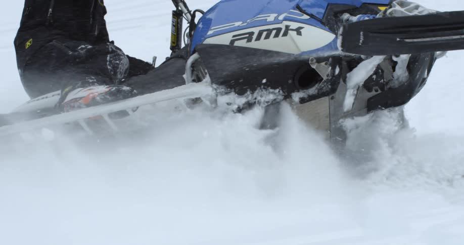 A person is riding a snowmobile during the day