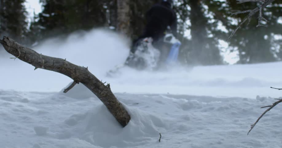Person performs tricks with snowmobile