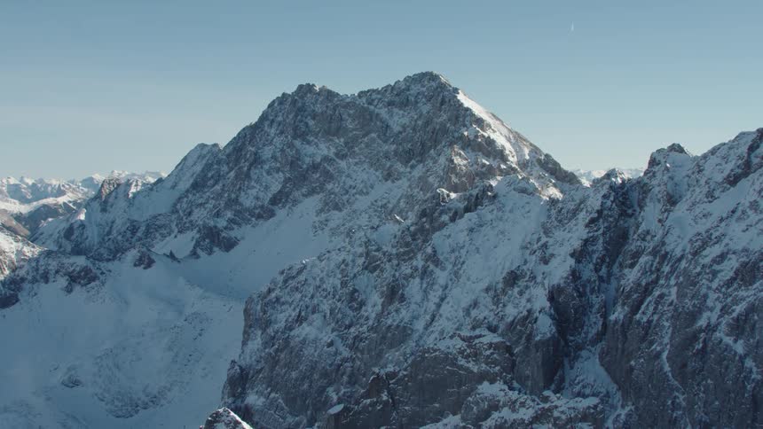 Aerial view of high steep snowy mountains