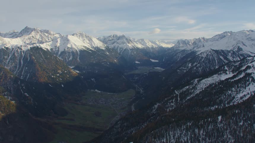 An aerial view of a mountain range with snow on it