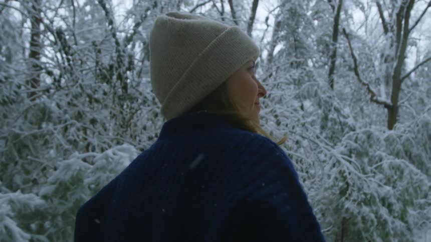 A woman is walking outdoors in winter