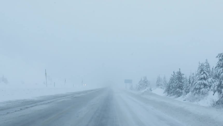 Moving down a road with a heavy snowstorm going on