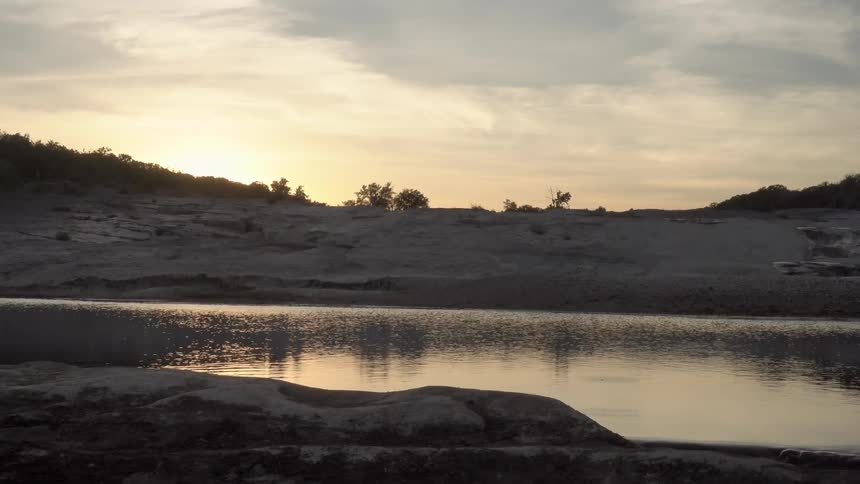 The sun is setting over a lake