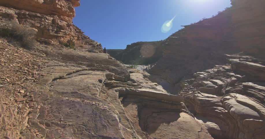 Sun shines on the canyon's striated rock formations