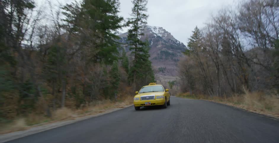 A view of a taxi driving down a road