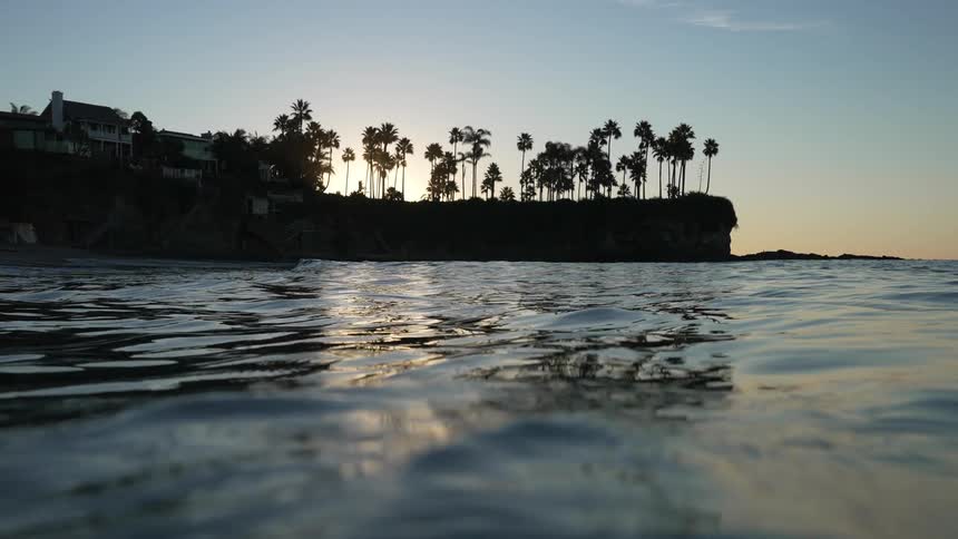 Waves moving in the water with a house on the shore