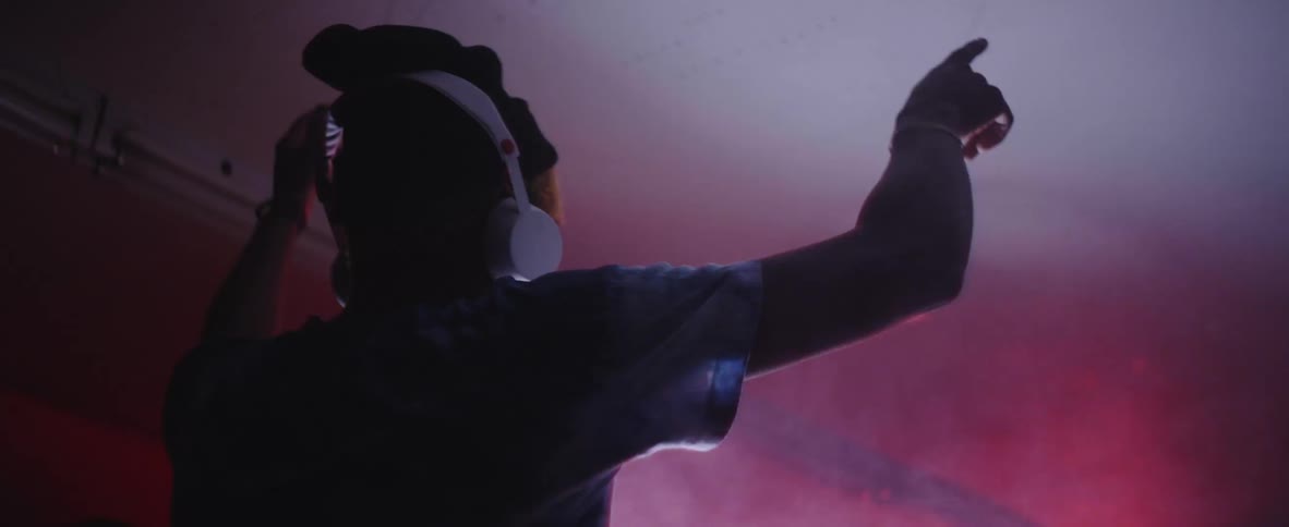 A dj in a club with headphones on