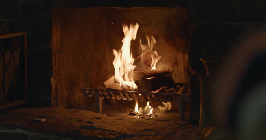 A fire burning in a fireplace in a home