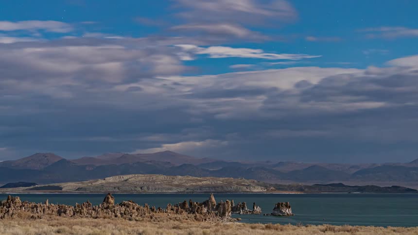 The clouds flow over the lake