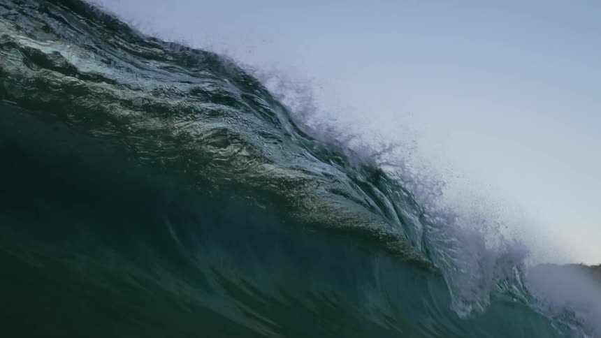 Large wave curls over blotting out sky