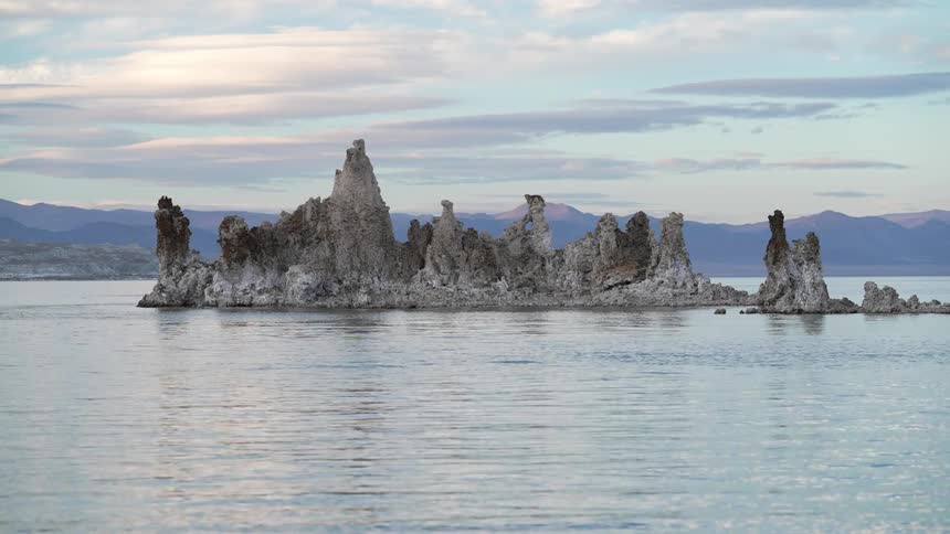 Jagged rock promontory over the calm lake surface at morning
