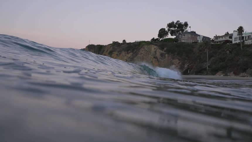 A wave moves past the shore on a sunny day
