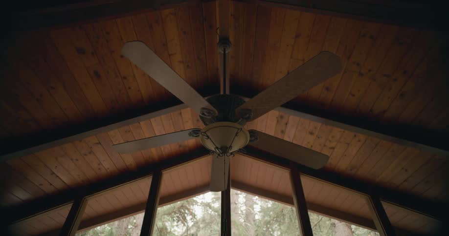 View of a large ceiling fan in a home with high ceilings