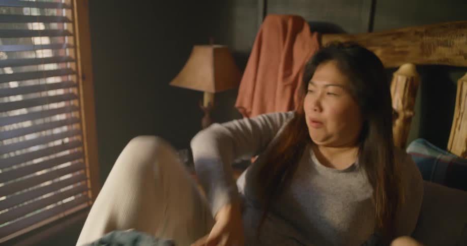 A sleeping woman wakes and suddenly realizes that she overslept and begins rushing
