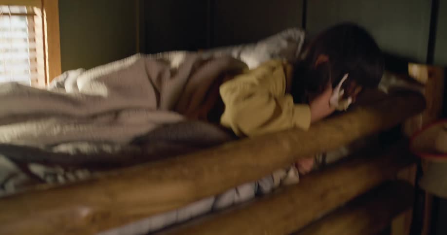 Light causes a girl in the top bunk to awaken and look down at her brother