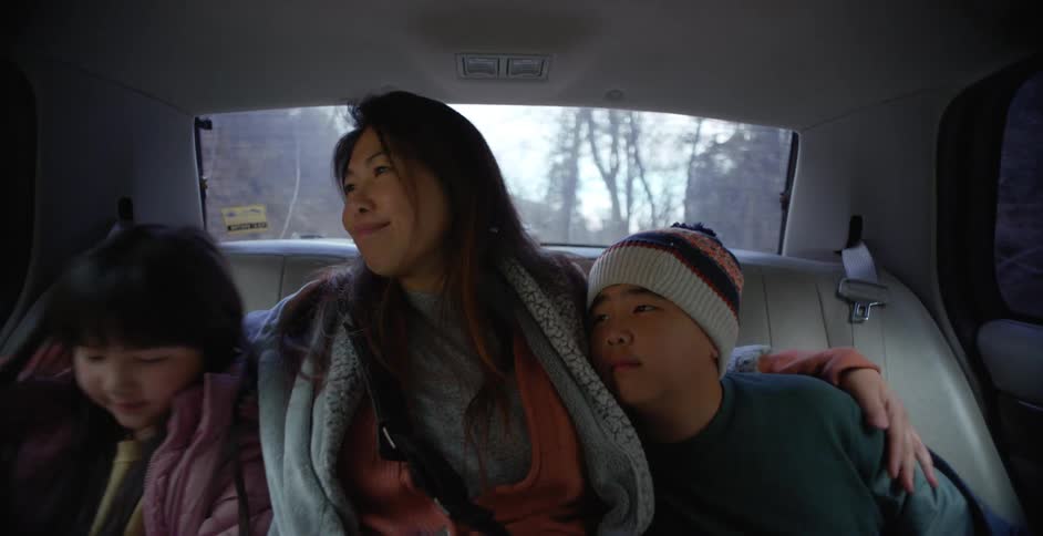 A mother and her children riding in a car