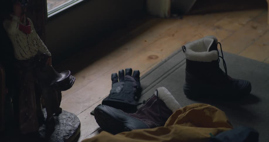 The boots and gloves are near the door