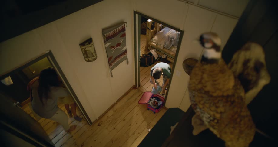 A woman is getting her children ready for school and pushing them around