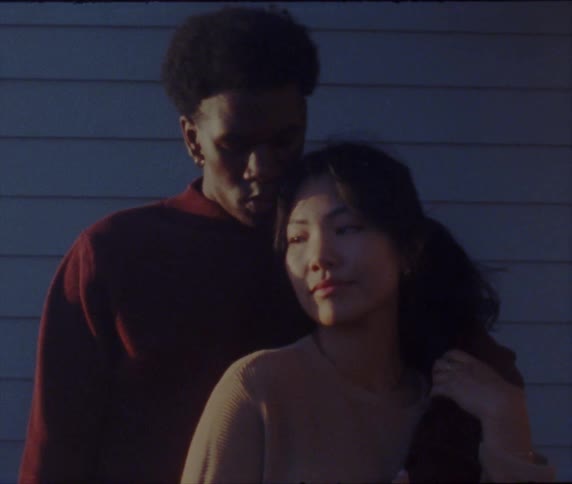 A couple pose outside together