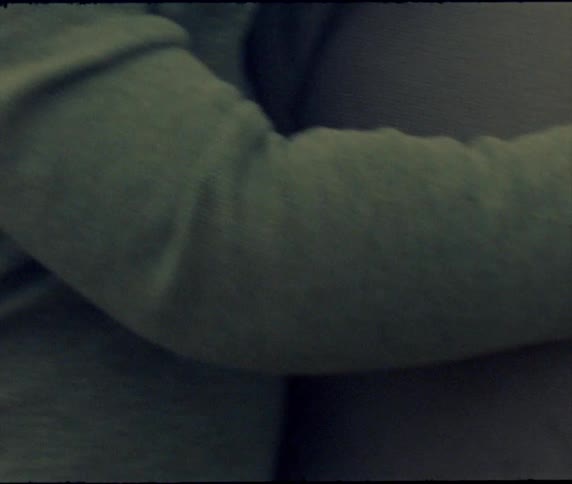Father with green sweatshirt holds baby boy