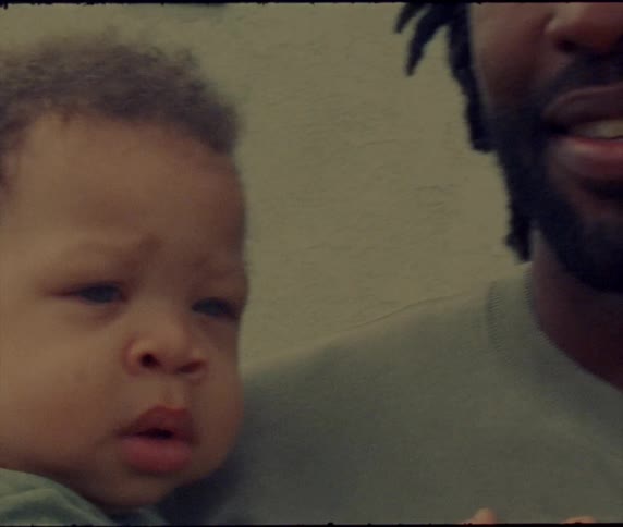 A man is holding a baby boy