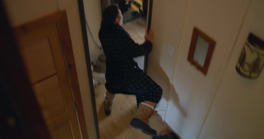 A family rushing around in a house packing