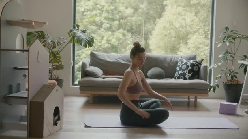 A woman stretching in a room