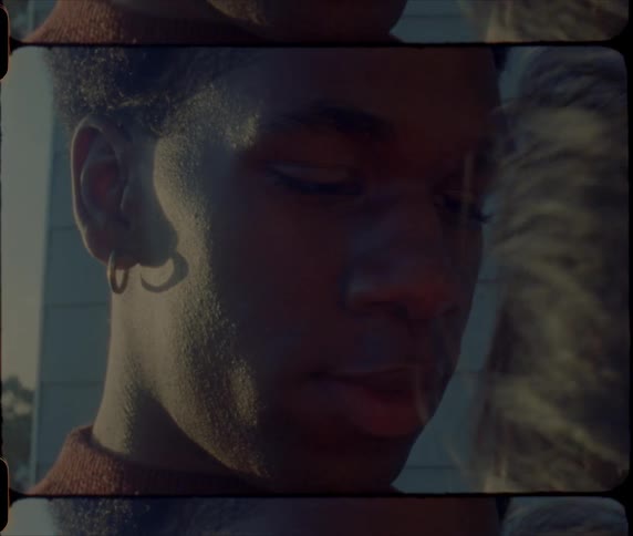 A man gazes lovingly at the woman in his arms