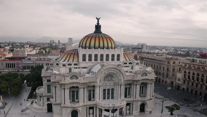 A rising aerial view of Palacio de Bellas Artes in a Mexico City neighborhood