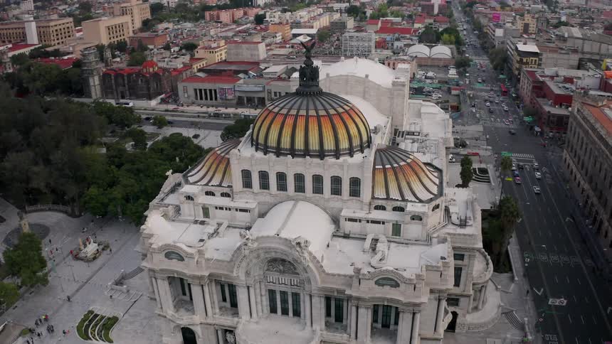 An aerial view of a large palace in Mexico City during the evening